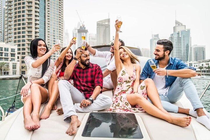 Sail through Dubai's stunning skyline aboard a 100 ft luxury yacht where laughter and celebration meet breathtaking views—perfect for unforgettable memories with friends amidst the picturesque waters.